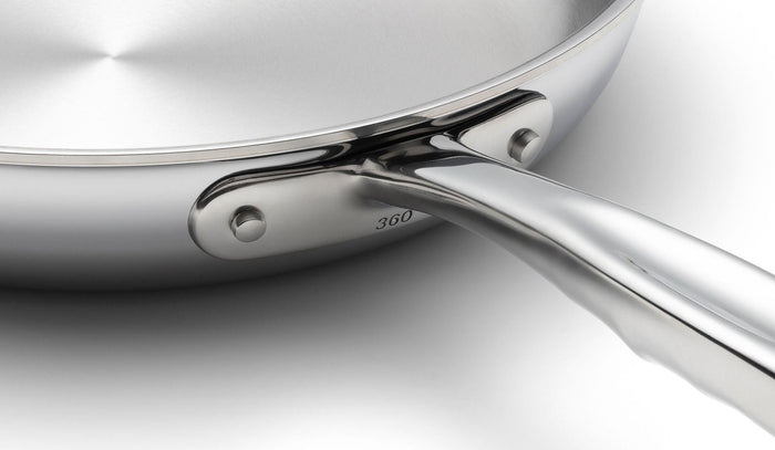 Close-up of 360 Cookware 7 inch stainless steel fry pan handle and side with polished finish on white background