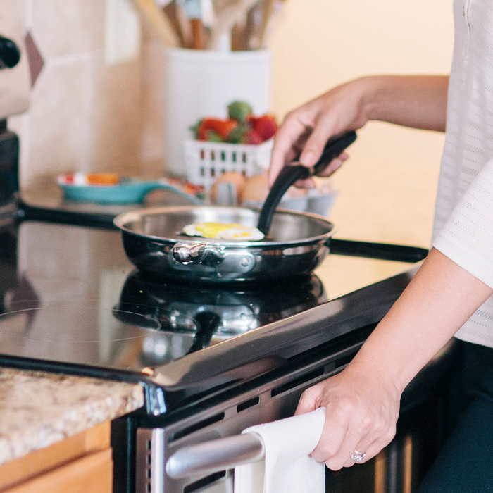 360 Cookware 7 inch stainless steel fry pan with black handle cooking eggs on stovetop in kitchen setting