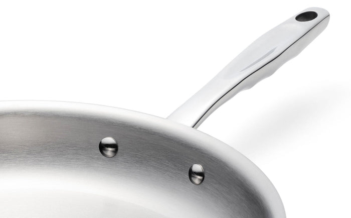 Close-up of 360 Cookware 7 inch stainless steel fry pan showing riveted handle and brushed metal interior surface