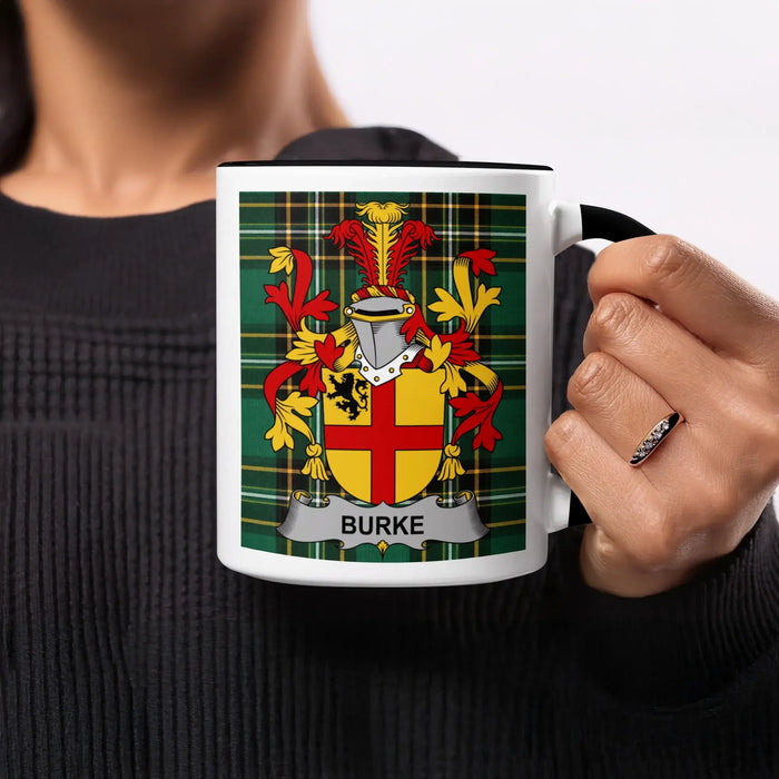 Burke tartan-background mug held by its black handle, showing the red-and-gold shield design.