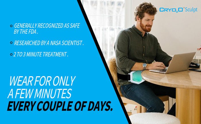 Man sitting at table using Cryo2O Sculpt Therapeutic fat-freezing belt during laptop work in bright room