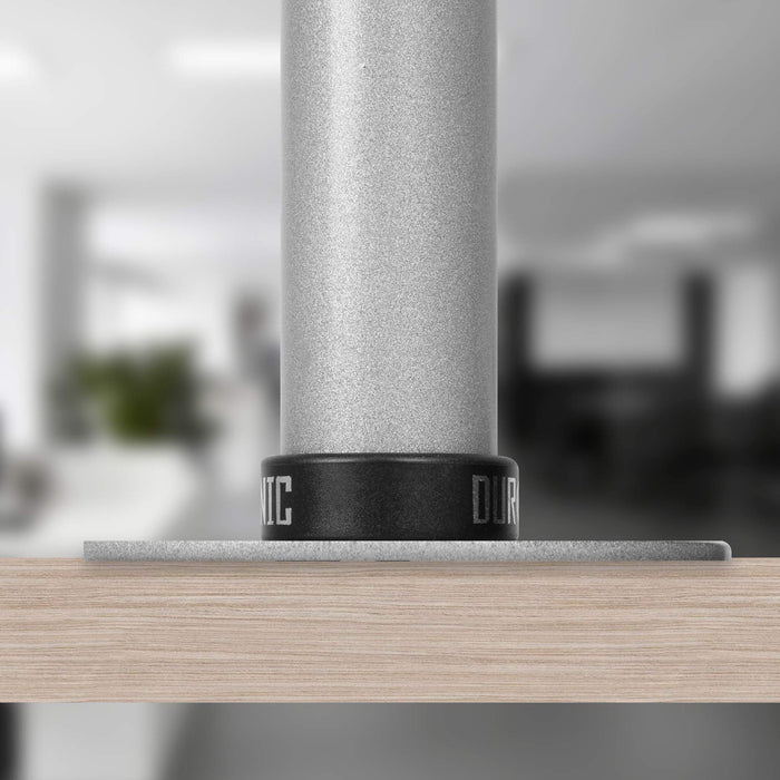 Duronic Grommet securely attached to a light wood desk surface, close-up view.