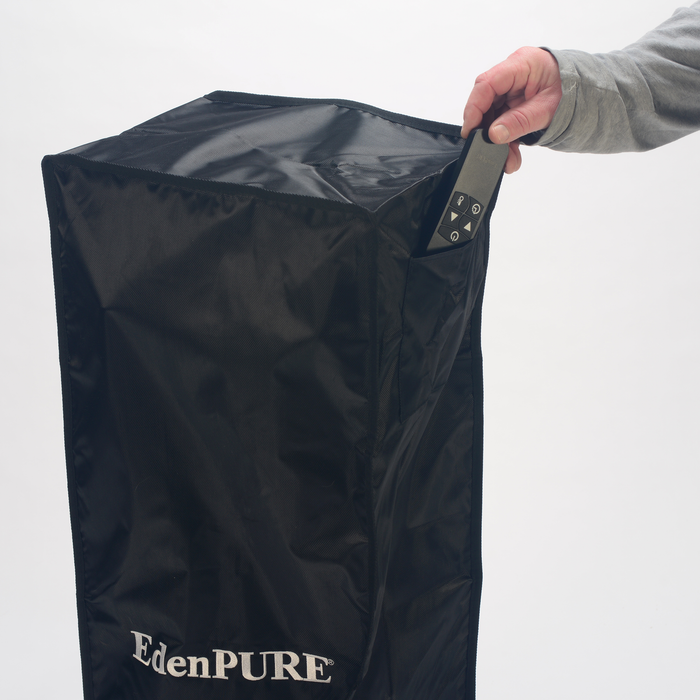EdenPURE All Season Indoor/Outdoor Heater Cover in black with hand inserting remote control into side pocket
