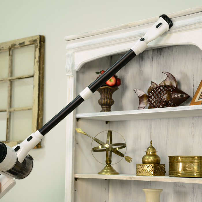 EdenPURE Bio SpeedCLEAN Cordless Vac VX300 with detachable brush head cleaning dust from white wooden shelf