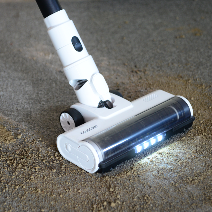 EdenPURE Bio SpeedCLEAN Cordless Vac VX300 cleaning dirt from carpet with illuminated brush head and white body