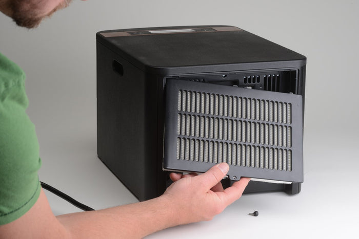 Installation of EdenPURE GEN21 Heater Air Purification Kit HEPA filter in black heater unit on white background
