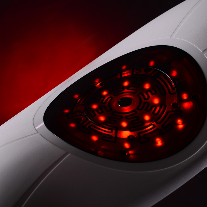 Close-up of EdenPURE PainNOT Smart Back Appliance showing red LED pain relief lights on white body
