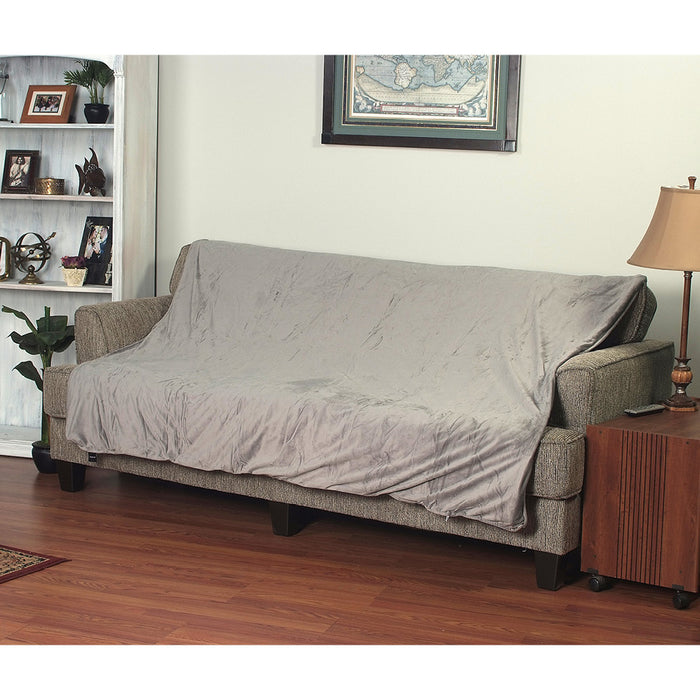 Gray EdenPURE Weighted Calming Blanket draped over beige sofa in cozy living room setting with lamp and bookshelf