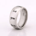 Inspirational Humanities ring in stainless steel engraved with live, grow, faith, and peace words on band isolated on white background