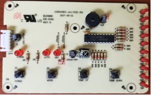 Front view of PC Control Board KN002 showing integrated circuits, resistors, capacitors, and connectors on beige circuit board
