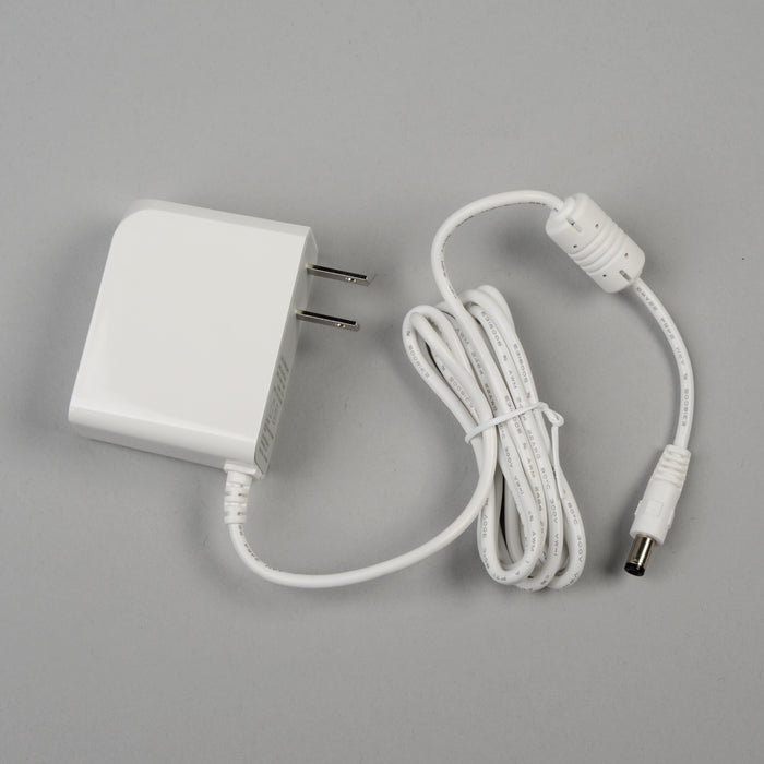 Replacement white A/C adapter for EdenPURE G9 air purifier with two-prong plug and coiled power cord isolated on gray background