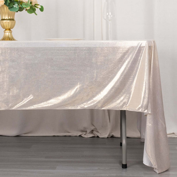 Elegant champagne satin tablecloth draping over a modern table.