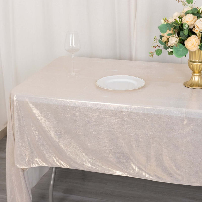 Elegant gold tablecloth draped over a table with a plate and flower vase.