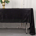 Elegant black tablecloth draping over a table with decorative elements.