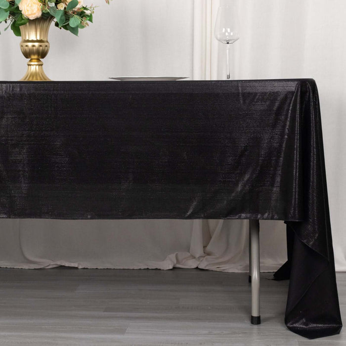 Elegant black tablecloth draping over a table with decorative elements.