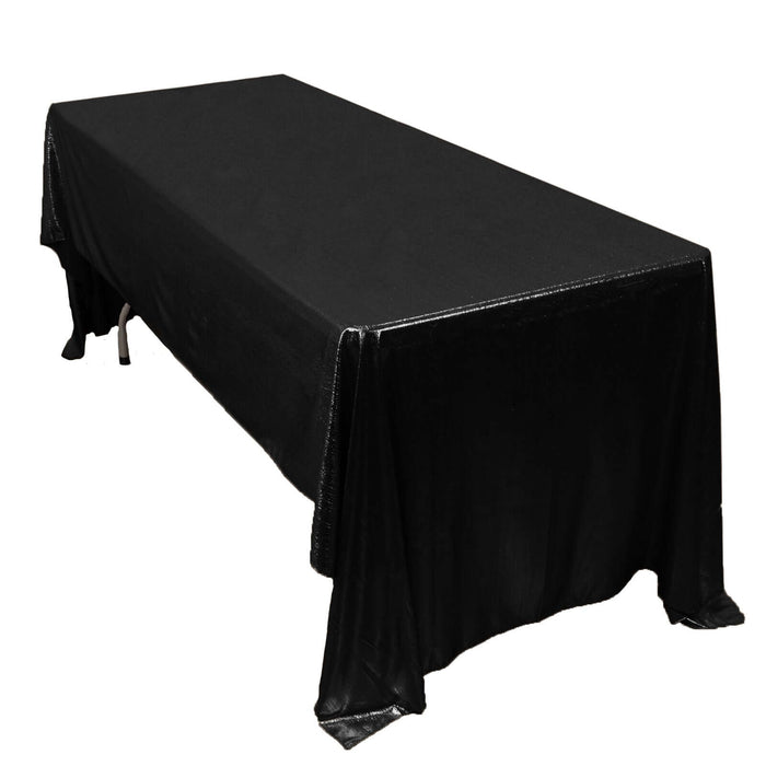 Black tablecloth draped over a rectangular table.