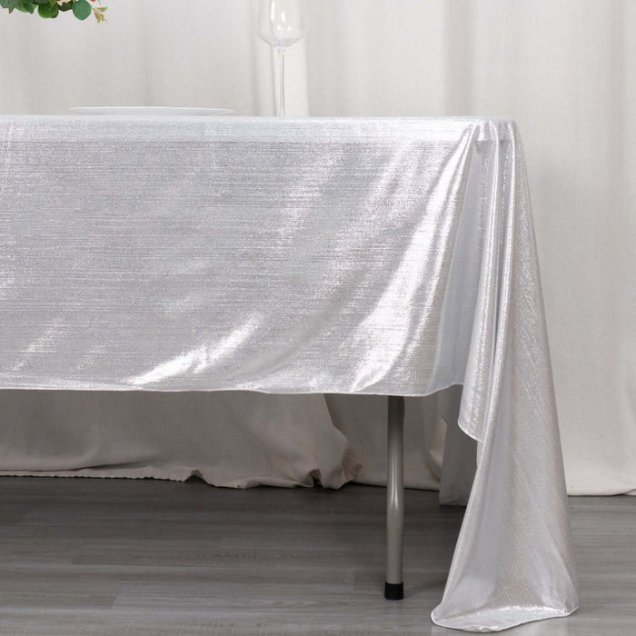 Shiny silver tablecloth draping over a table edge.