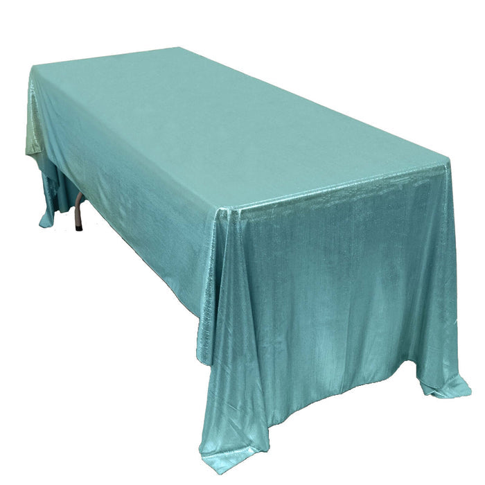 Turquoise tablecloth draped elegantly over a rectangular table