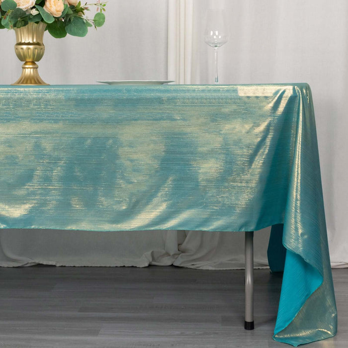 Turquoise tablecloth draped over a table with elegant decor.