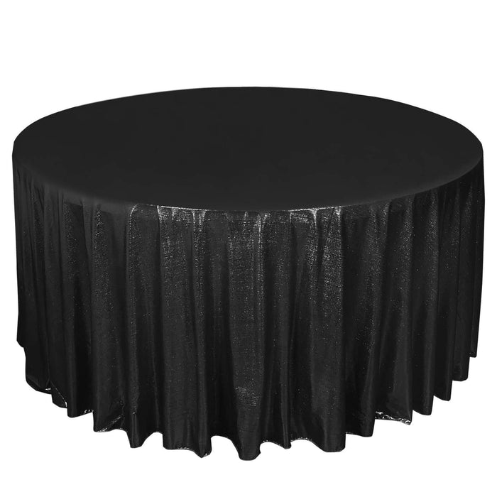 Round black tablecloth with shimmering texture on a plain background