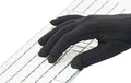 Black Writer's Glove® designed for typing with touchscreen-compatible fingertips on white keyboard background