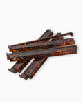Set of tortoiseshell-patterned mahjong racks on a white background