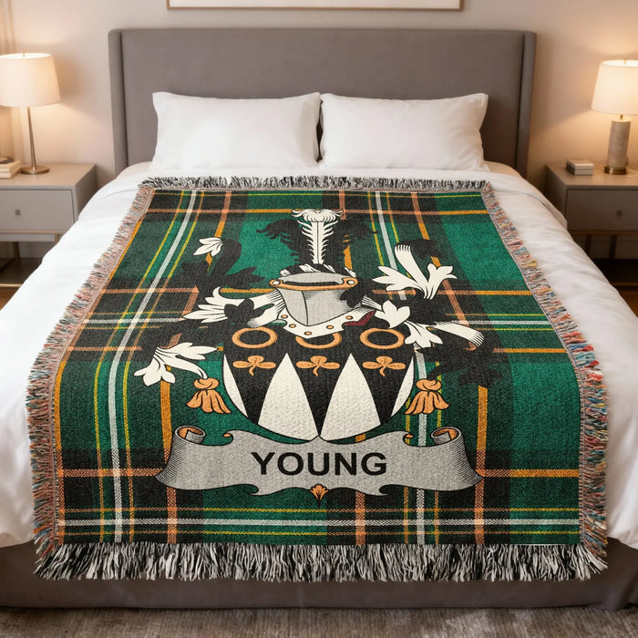 Young Irish family crest woven blanket displayed on a bed.